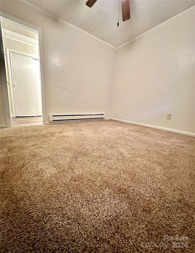 empty room with ceiling fan, baseboard heating, carpet, and crown molding