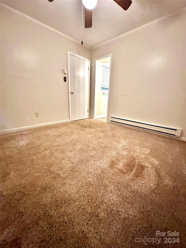 spare room featuring ceiling fan, baseboard heating, and ornamental molding