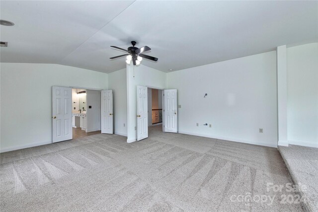 1013 Taylor Glenn Ln, Indian Trail, NC 28079 - unfurnished bedroom featuring lofted ceiling, light carpet, visible vents, and baseboards