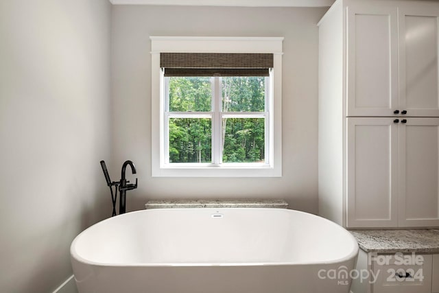 bathroom with a tub to relax in