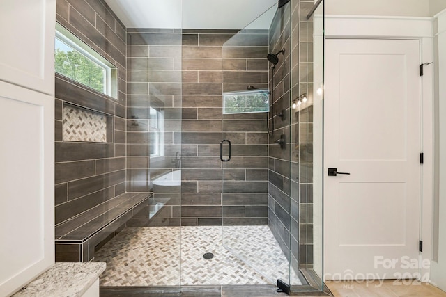 bathroom with a shower with shower door