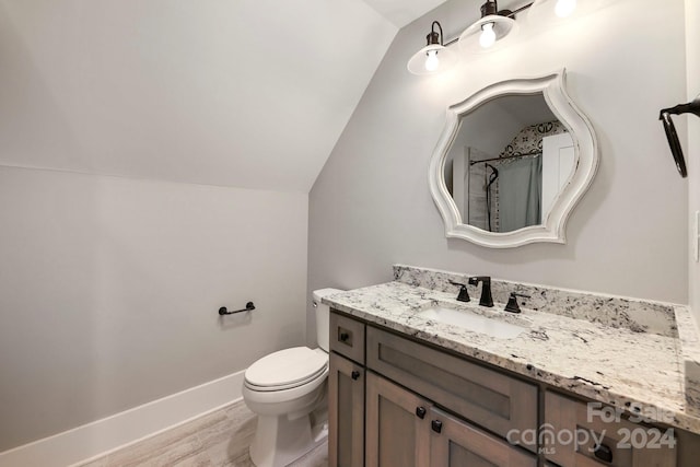 bathroom featuring hardwood / wood-style floors, vaulted ceiling, toilet, vanity, and a shower with shower curtain