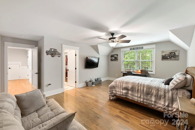 bedroom with lofted ceiling, light wood-type flooring, and ceiling fan