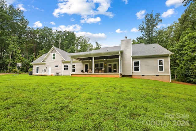 rear view of property with a patio area, a yard, and ceiling fan