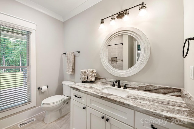 bathroom featuring vanity, toilet, and ornamental molding