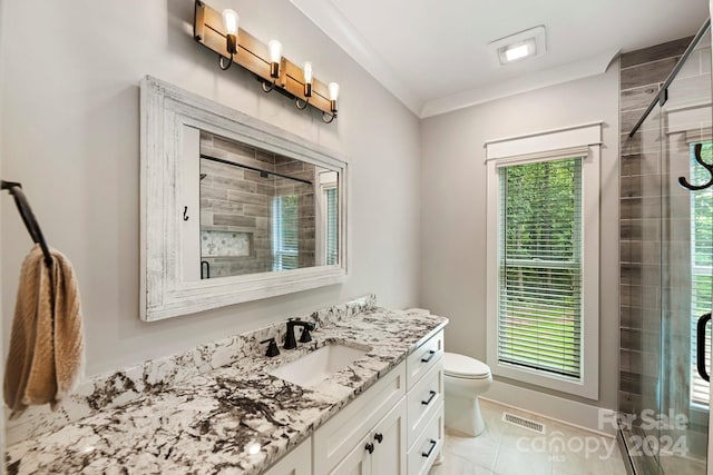 bathroom featuring toilet, ornamental molding, vanity, an enclosed shower, and tile patterned flooring