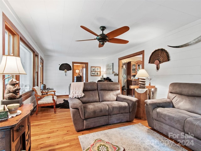 living area with ceiling fan and wood finished floors