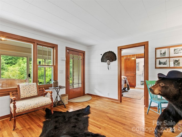 living area featuring light wood-style floors and baseboards