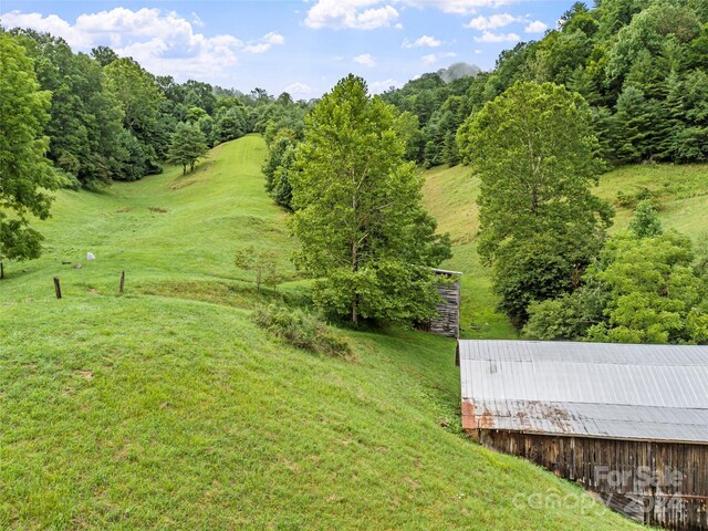 view of yard with a rural view and an outdoor structure