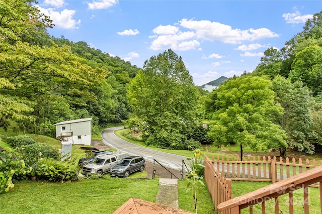 exterior space featuring a yard, fence, and a mountain view