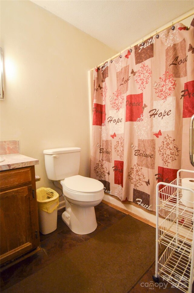 bathroom featuring toilet, a shower with curtain, and vanity