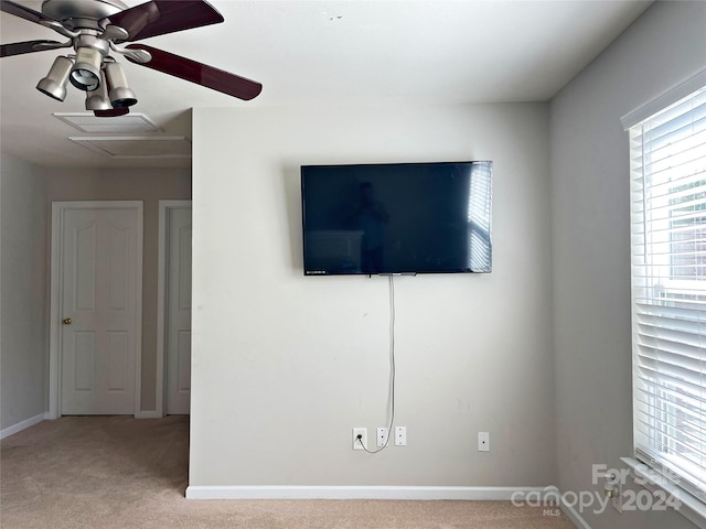 interior space with baseboards, carpet, and a ceiling fan