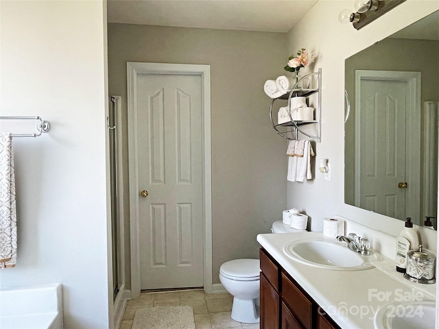 bathroom with tile patterned flooring, toilet, double vanity, a stall shower, and a sink