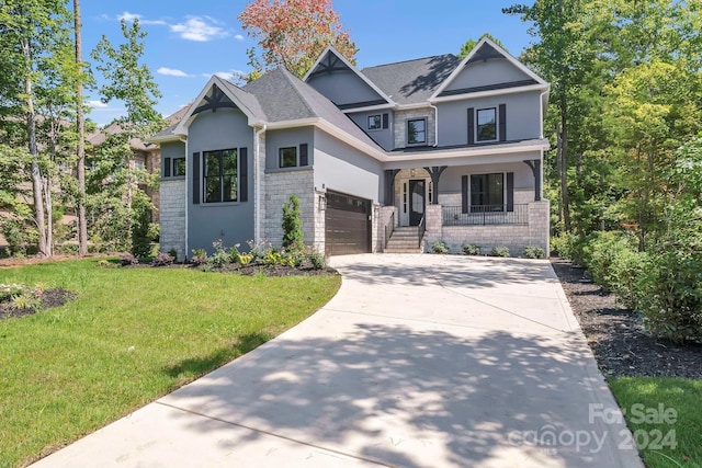 craftsman-style house featuring a porch, a garage, and a front lawn