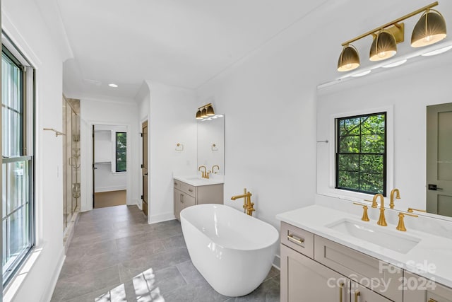 bathroom with double vanity, a bathtub, and tile patterned floors