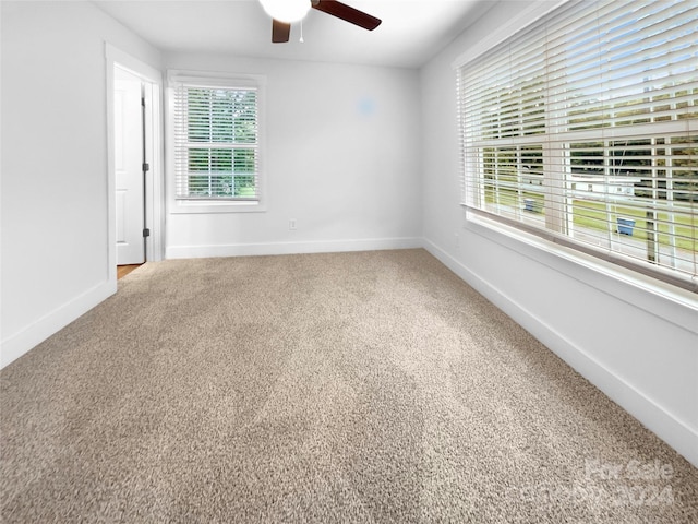 unfurnished room with carpet floors and ceiling fan