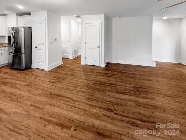 unfurnished living room featuring dark wood-type flooring