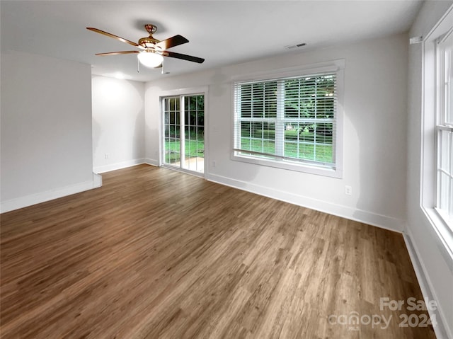 empty room featuring hardwood / wood-style flooring and ceiling fan