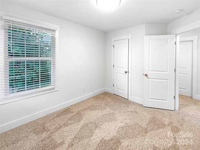 unfurnished bedroom with a closet and carpet