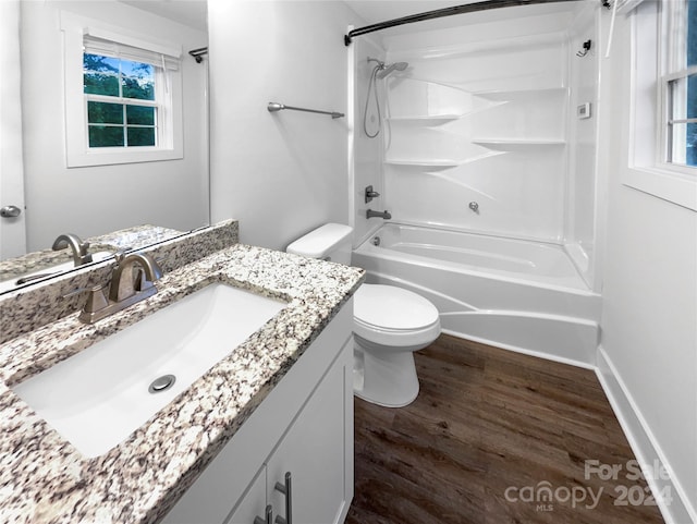 full bathroom with hardwood / wood-style flooring, shower / bath combination, toilet, and vanity