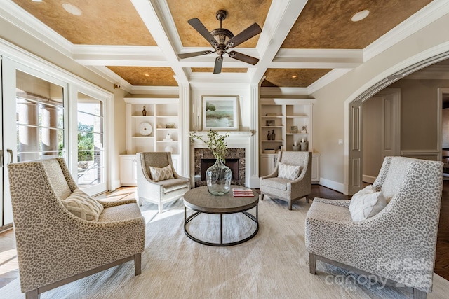 living room with ornamental molding, a fireplace, coffered ceiling, and beamed ceiling