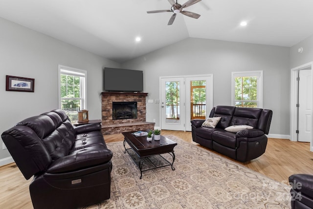 living room featuring a healthy amount of sunlight, ceiling fan, light wood-type flooring, and lofted ceiling