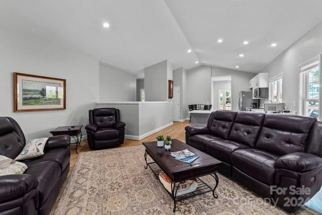 living room featuring light hardwood / wood-style flooring and lofted ceiling