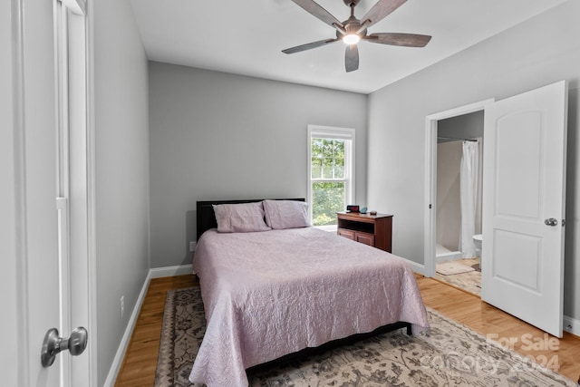 bedroom featuring connected bathroom, light hardwood / wood-style flooring, and ceiling fan