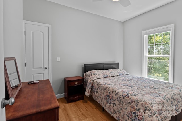 bedroom with light hardwood / wood-style flooring and ceiling fan