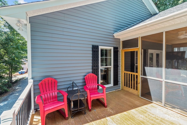 wooden deck with a sunroom