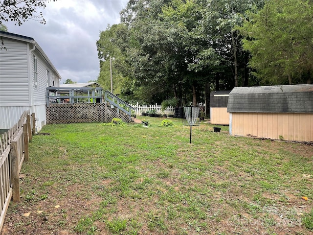 view of yard featuring a storage shed and a deck