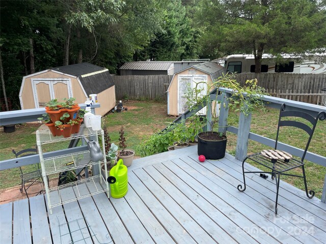 wooden terrace featuring a shed