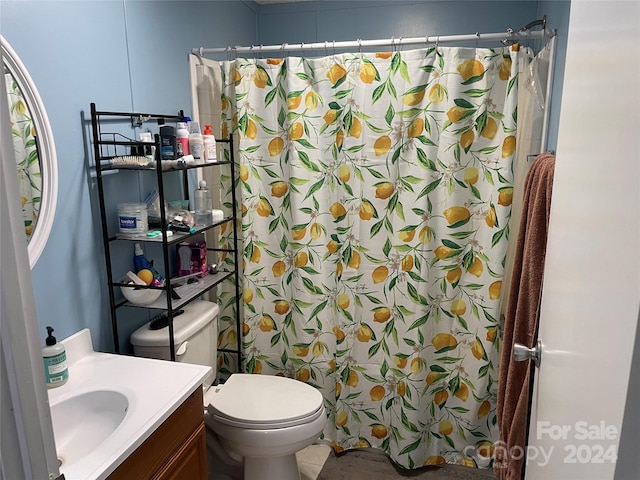 bathroom with vanity, curtained shower, and toilet