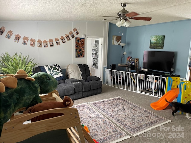 living room with ceiling fan, carpet floors, and a textured ceiling