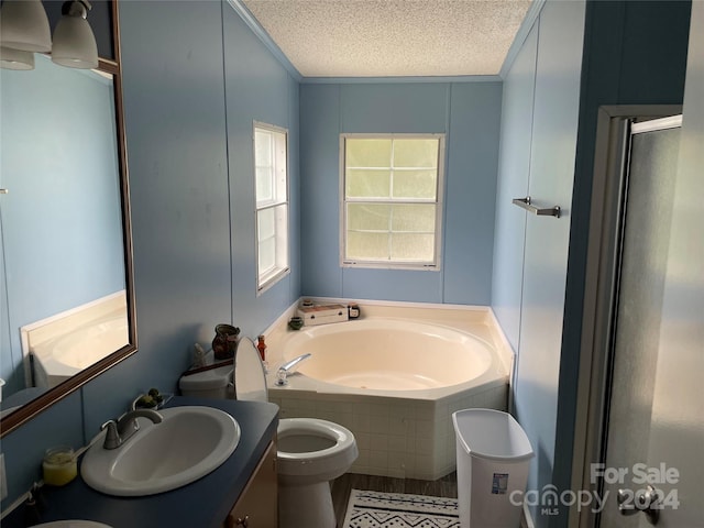 bathroom featuring a relaxing tiled tub, vanity, ornamental molding, a textured ceiling, and toilet