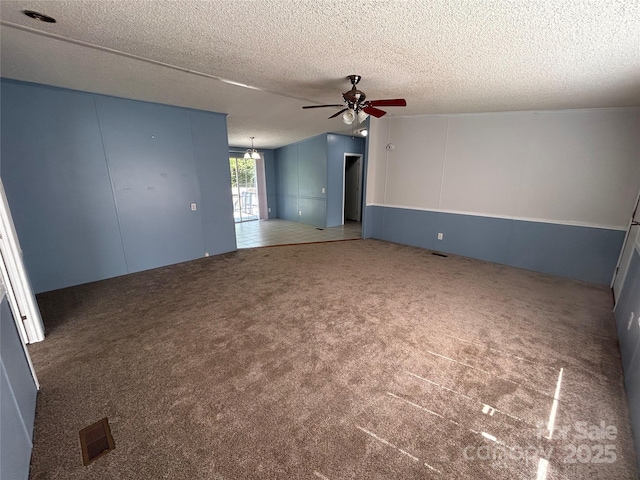 6261 Burnhurst Ln, Denver, NC 28037 - spare room featuring ceiling fan, carpet flooring, a textured ceiling, and a chandelier