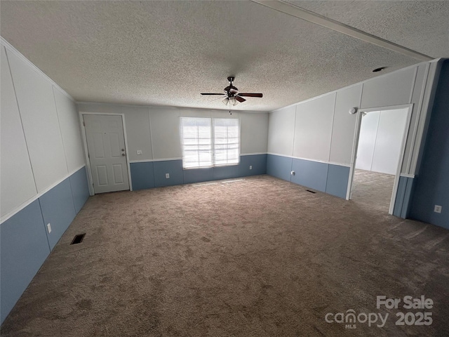 6261 Burnhurst Ln, Denver, NC 28037 - carpeted empty room featuring ceiling fan, a textured ceiling, and a decorative wall