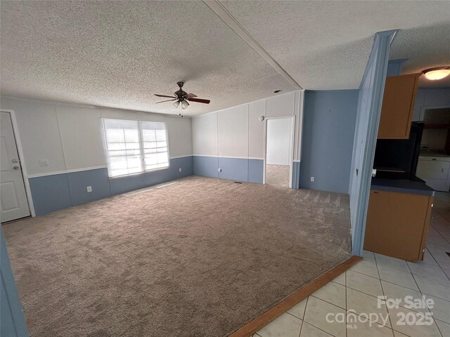 6261 Burnhurst Ln, Denver, NC 28037 - unfurnished living room with a ceiling fan, a textured ceiling, carpet, separate washer and dryer, and tile patterned floors