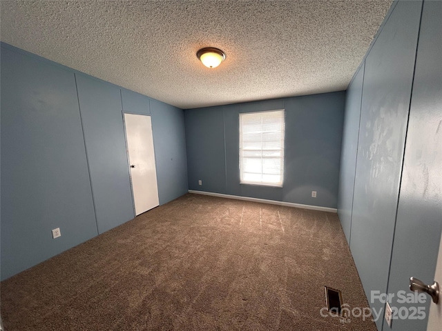 6261 Burnhurst Ln, Denver, NC 28037 - spare room featuring carpet floors and a textured ceiling