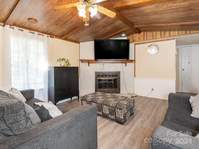 living room featuring ceiling fan, lofted ceiling with beams, light hardwood / wood-style flooring, and wooden ceiling