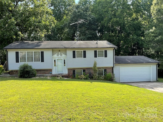 split foyer home with a front yard and a garage