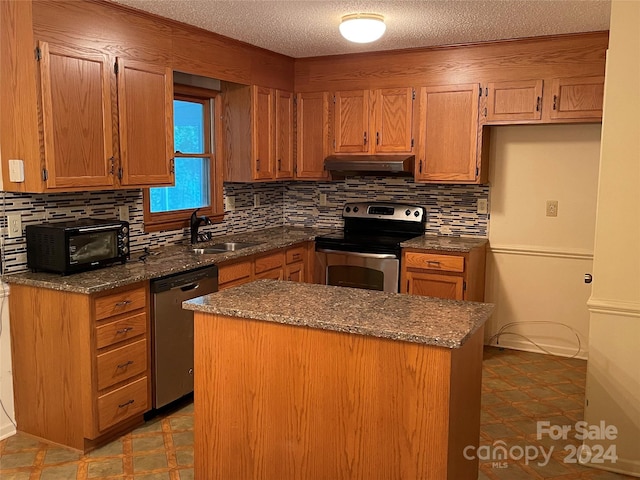 kitchen with sink, backsplash, appliances with stainless steel finishes, and dark stone counters