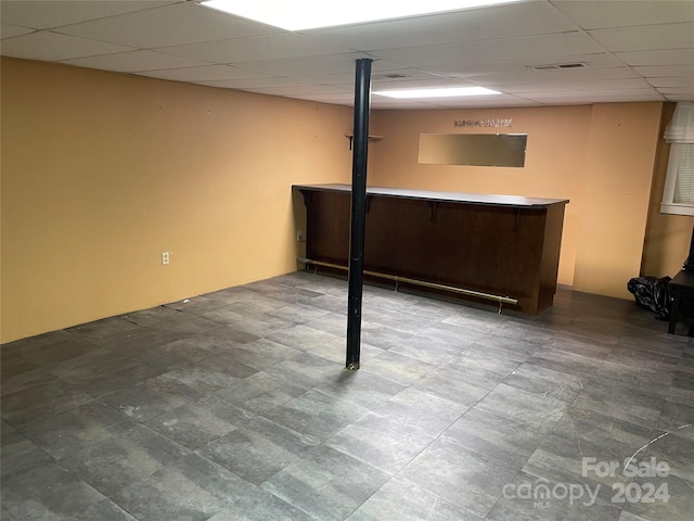 basement featuring a paneled ceiling