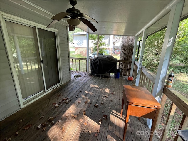 wooden terrace with ceiling fan and a grill