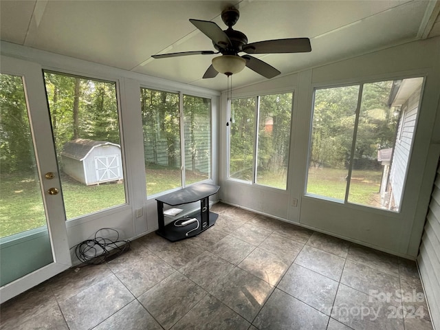 unfurnished sunroom featuring ceiling fan and vaulted ceiling