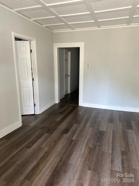 empty room with dark hardwood / wood-style floors