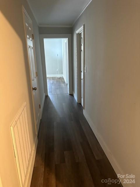 hall featuring dark hardwood / wood-style flooring and ornamental molding