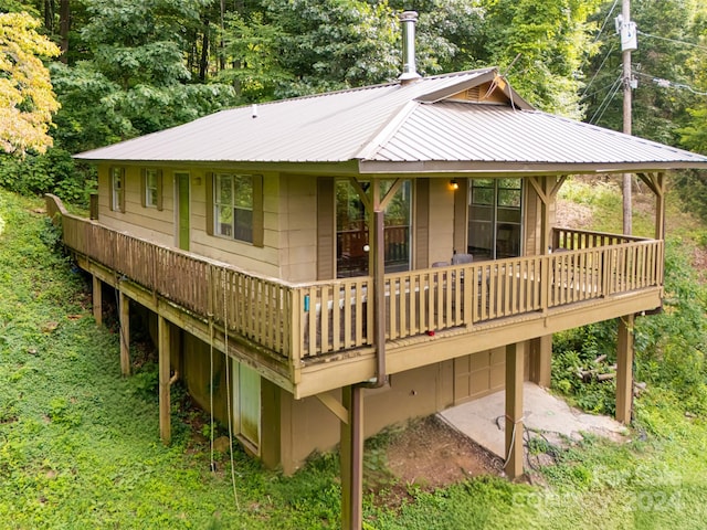 back of property with a wooden deck