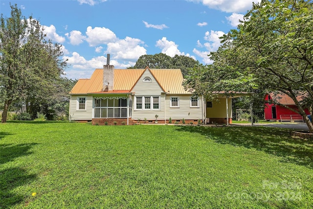 rear view of property featuring crawl space, a chimney, metal roof, and a yard