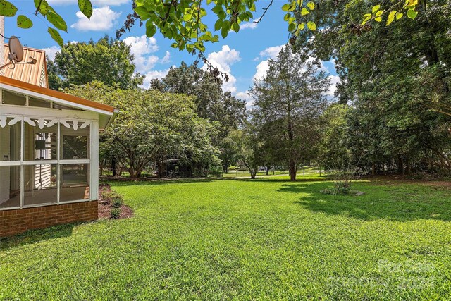 view of yard with a sunroom